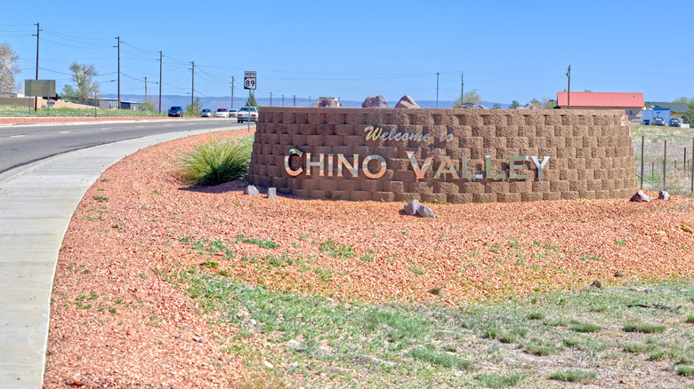 A chrome and brick sign reads "Welcome to Chino Valley"