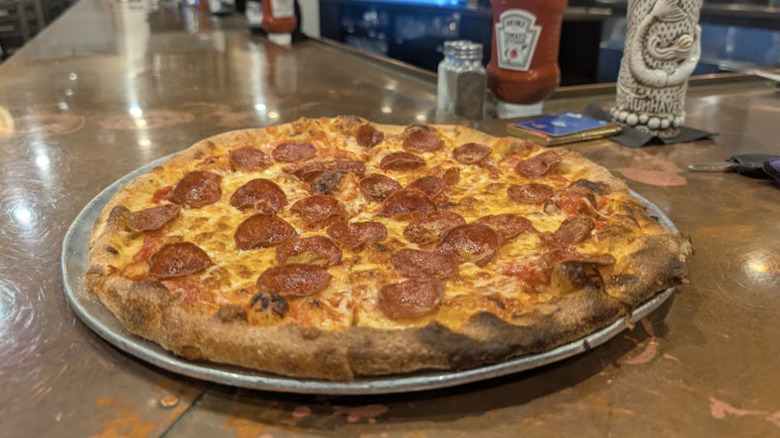 Close-up of the pizza on the bar counter at Baldie's Craft Pizzeria in Lakeville, MA