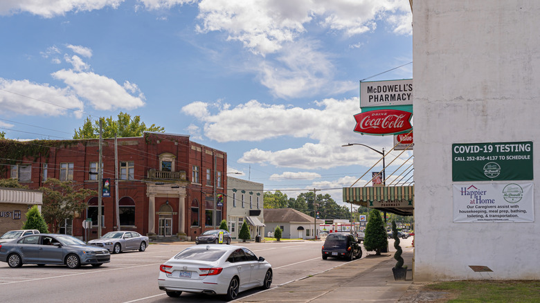 Scotland Neck historic downtown with brick buildings, the McDowell's Pharmacy sign, cars on the street, and blue skies