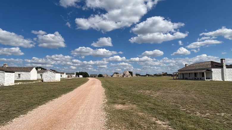 A dirt road leads through the Fort McKavett State Historic Site in Texas