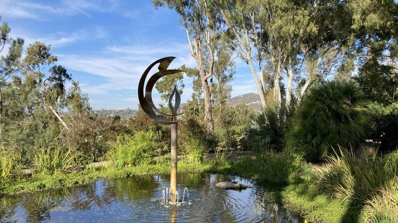 A sculpture of the Golden Torsion in the Pond by Lia Strell in the Ceremonial Garden at Alta Vista Botanical Gardens in Vista, California