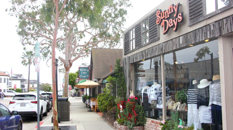 A boutique shop and, beyond, a restaurant along the main street of Balboa Island in California