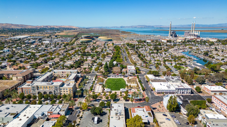 aerial view of buildings and parks with a lake in the distance in downtown Pittsburg, California
