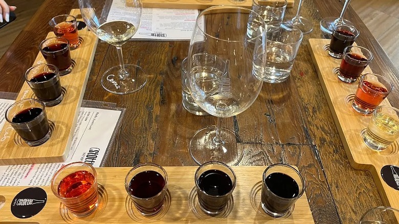 Small flights of wine and wine glasses on a timber table during a wine tasting at Stottle Winery.