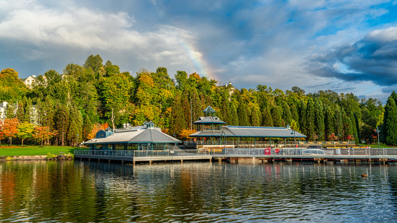 rainbow over trees and lake, Gene Coulon Park in Renton, Washington.