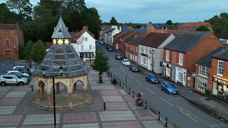 Bingham market with octagonal cross and brick buildings gray sky.