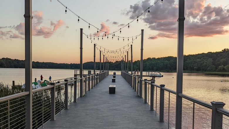 A view of Stone Lake Beach's pier, with a sunset in the background