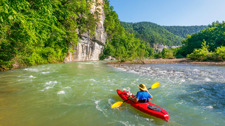 A kayaker on the Buffalo National River on a sunny day