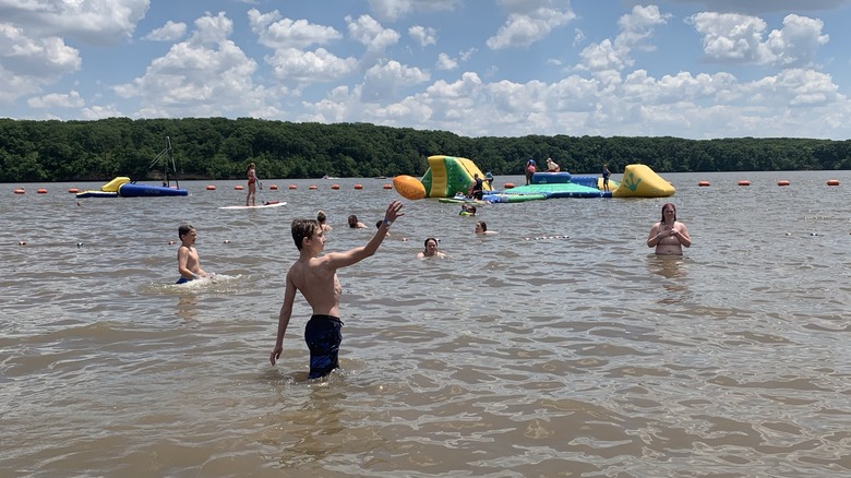 Beachgoers enjoying water at Lake Lou Yaeger's Milnot Beach