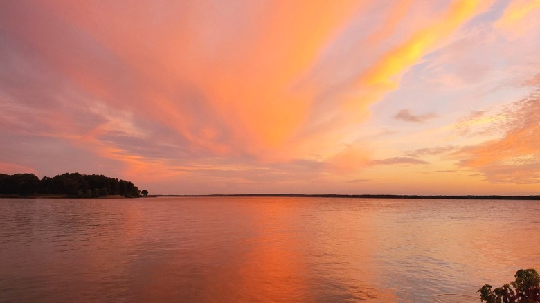 Vibrant pinks, blues, oranges, and purples in the sky over the lake at Wayne Fitzgerrell State Recreation Area