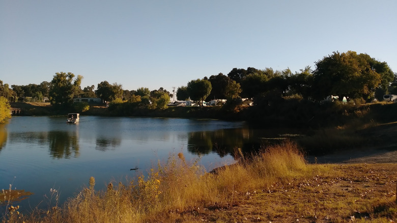 A picture of the Turtle Beach campground with boat on river
