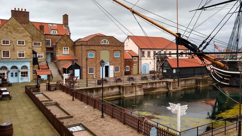 Historic brick buildings surround the bow of HMS Trincomalee in Hartlepool Marina