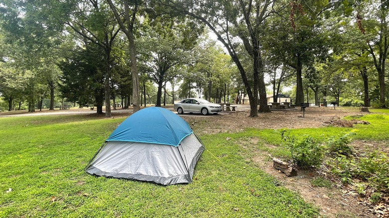 Tent on a grassy campsite surrounded by trees at the Twin Bridges Area at Grand Lake State Park, Oklahoma