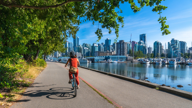 A bike-rider cruising along the water in Vancouver, British Columbia, Canada