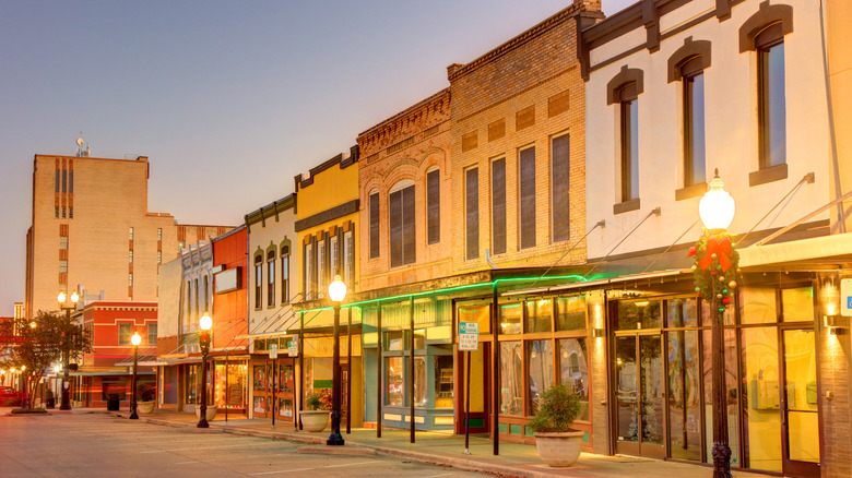 Historic Downtown Bryan, Texas, in the evening hours, with street lamps lighting the area