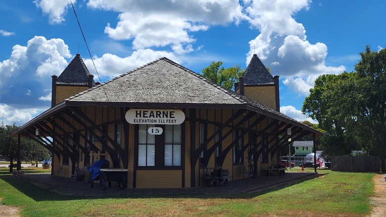 The Hearne Depot Railroad and Local History Museum in Hearne, Texas, with an arrow-shaped facade and a sign that says "Elevation 311 feet" on a cloudy day