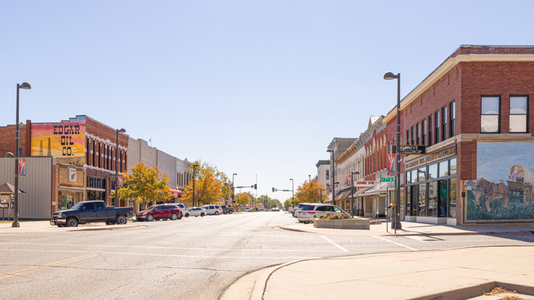 Street view of brick storefronts in Wellington, Kansas on sunny autumn day.