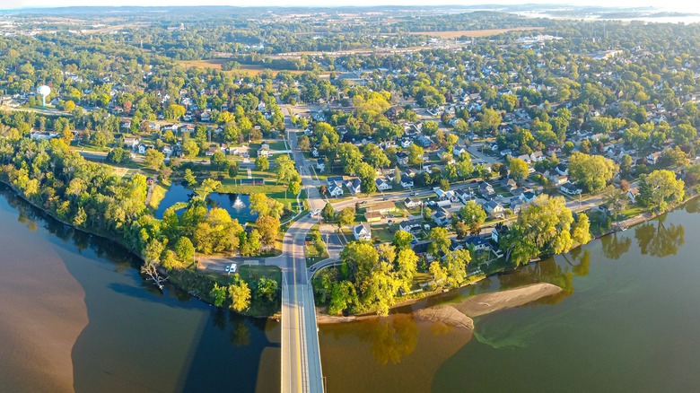 Aerial photo of Portage from above the Wisconsin River with a bridge entering the riverside town and its tree-lined streets