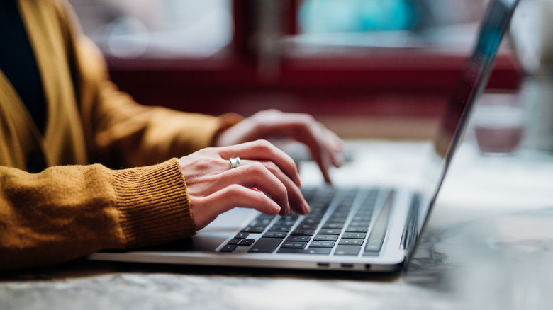 Woman typing on a laptop