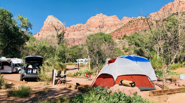 campers, car, and tent in designated campground in Zion National Park
