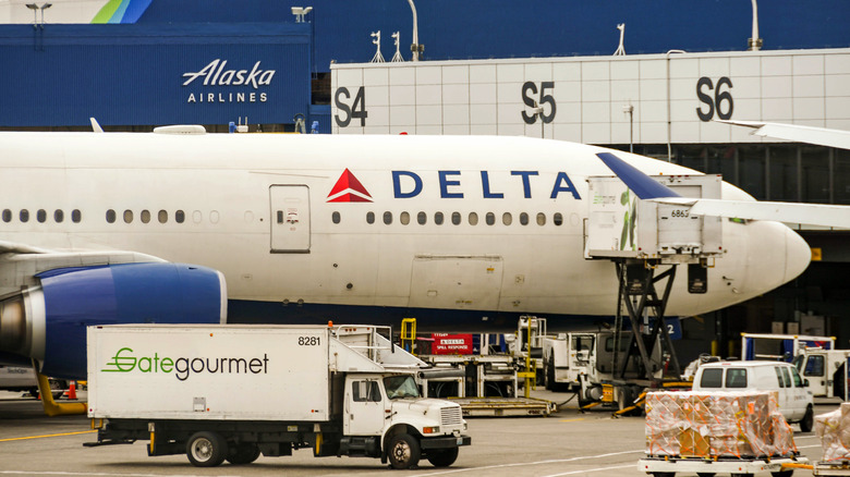 Gate Gourmet truck outside a Delta Airlines plane