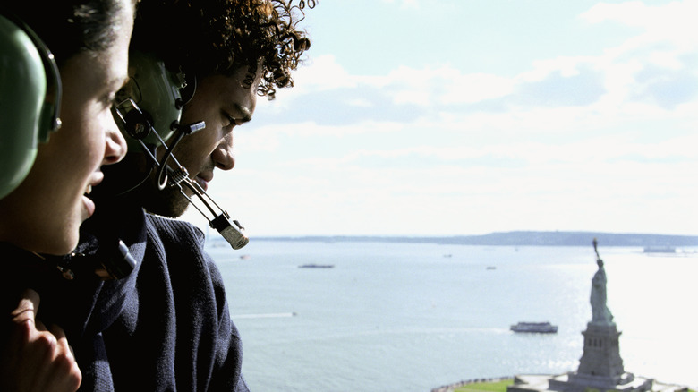 Tourists looking at the Statue of Liberty from a helicopter