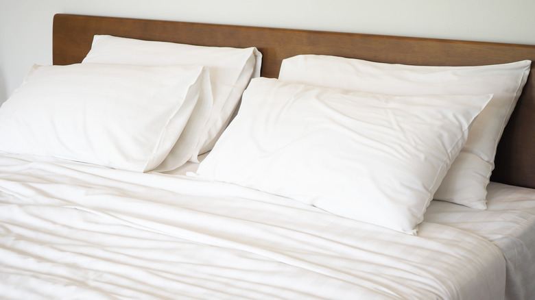 Ruffled white sheets and pillows