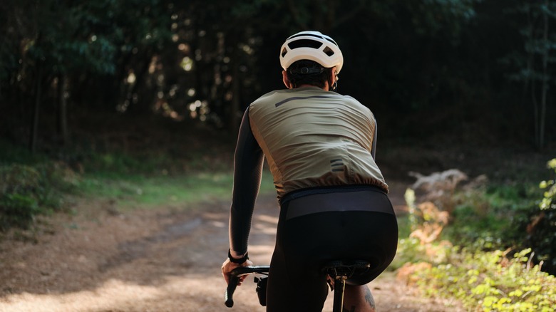 Cyclist riding along shaded path