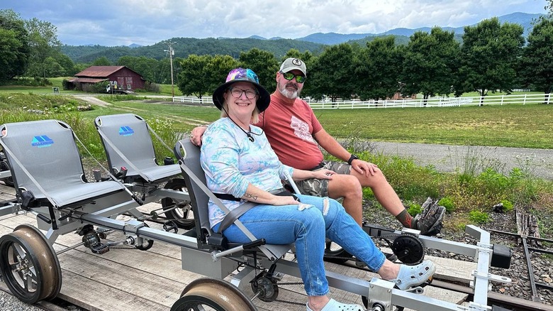 A couple ride a rail bike in the Blue Ridge Mountains.