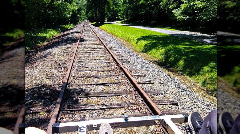 People pedal rail bikes along a railway in the Blue Ridge Mountains.
