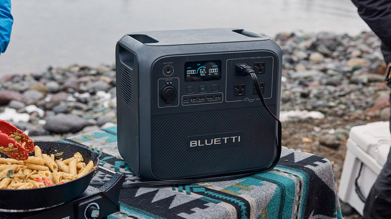 BLUETTI power station on blanket near river