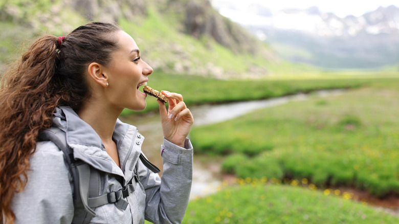 A person eating on a hike