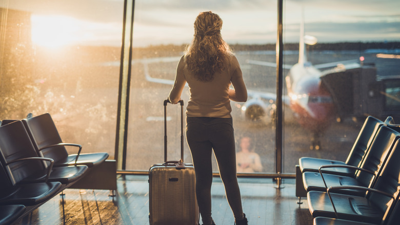 woman waits for early flight