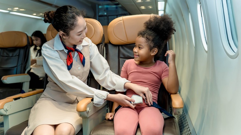 flight attendant helping child