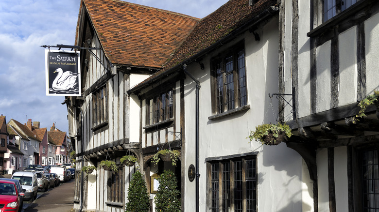 Hanging baskets outside Lavenham's Swan Hotel & Restaurant, which has a white facade with black beams