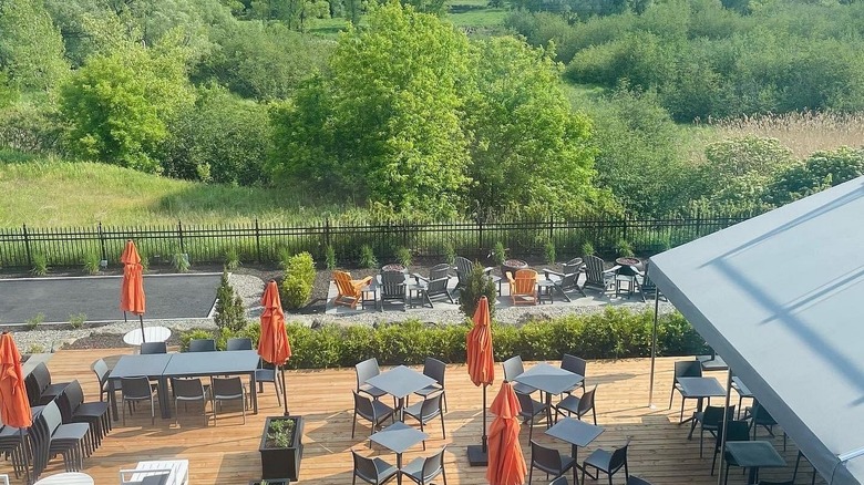 Terrace at Le Roux and greenery behind it