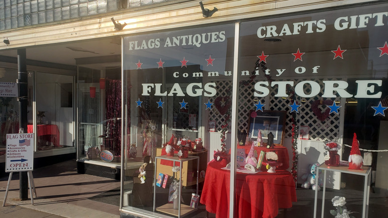 The entrance to the Community of Flags store in Brooklyn, Iowa with signage and displays