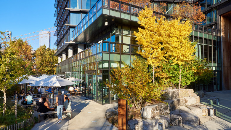 People dining outside at The Osprey in 1 Hotel Brooklyn Bridge on a clear day