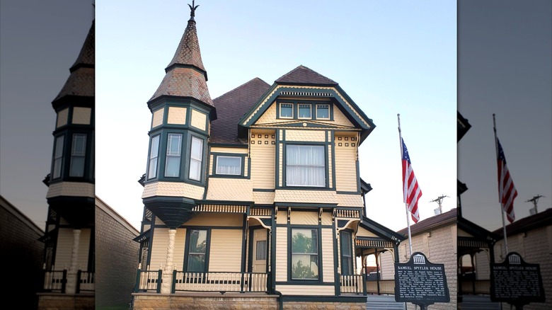 Yellow with green trim Queen Anne-style historic Spitler House in Brookville Ohio