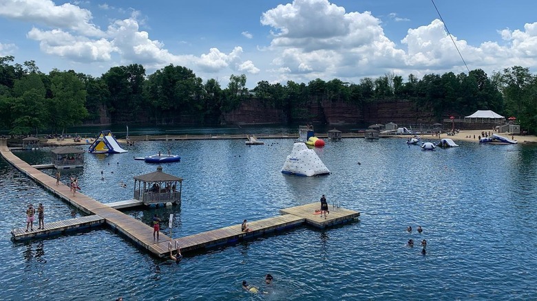 Brownstone Adventure Sports Park in Portland, Connecticut, with inflatable water obstacles and wooden paths over the water