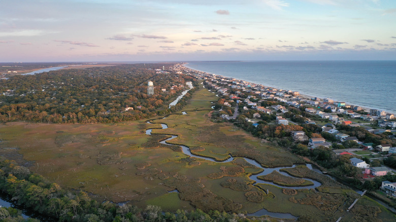 An aerial view the houses, forest, and marsh of Oak Island in Brunswick County, NC