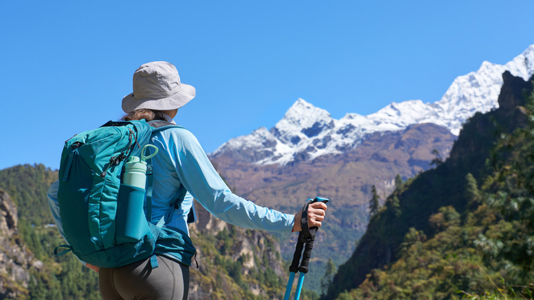 Backpacker admiring the Himalayas on the way to Everest Base Camp