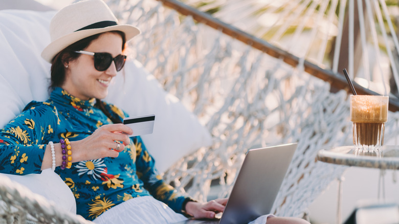 happy woman beach credit card computer