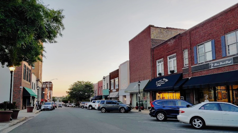 Burlington, North Carolina, downtown at sunset with cars parked alongside buildings