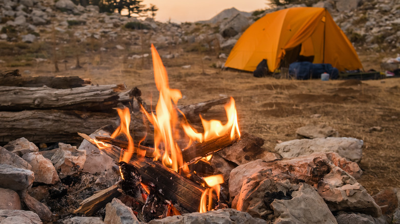 Campfire next to a tent