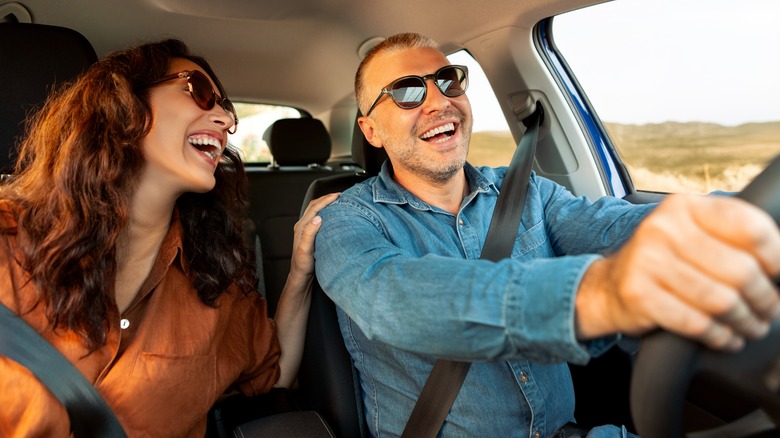 Laughing couple in a car