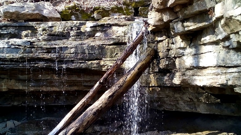 A small waterfall cascades over a large rock at Buzzard Roost Recreation Area.