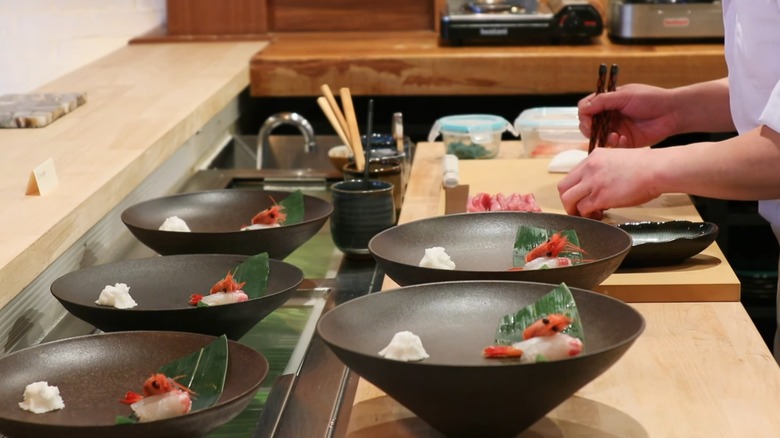 Chef preparing a course at Rebel Omakase in Laguna Beach