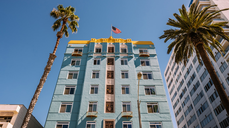 The Georgian Hotel rises above palm trees in Santa Monica, California