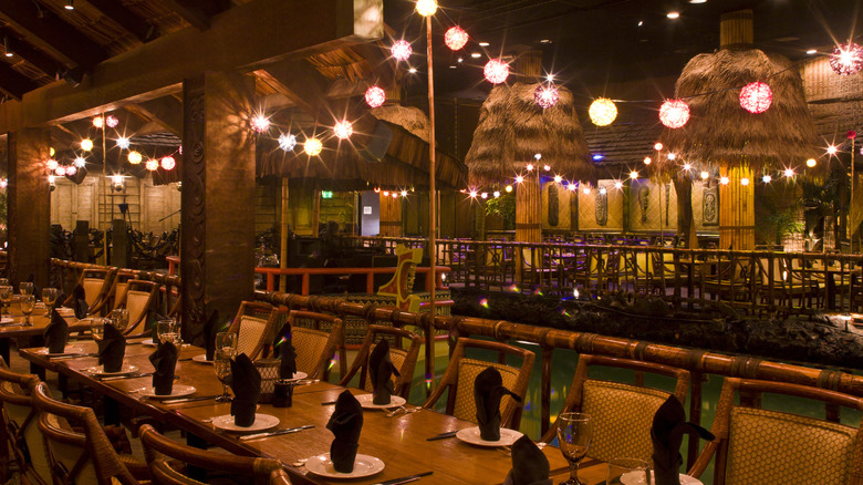 The interior of the Tonga Room that shows a long table and the pool with the flaoting stage